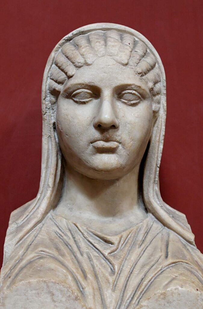 Escultura "Busto de Aspasia", de autoria indefinido. Feita em mármore, possivelmente é uma cópia romana de uma escultura grega. Possivelmente é a ela que o eu-lírico está fazendo referência, já que ela está coberta em um véu, como descrito.